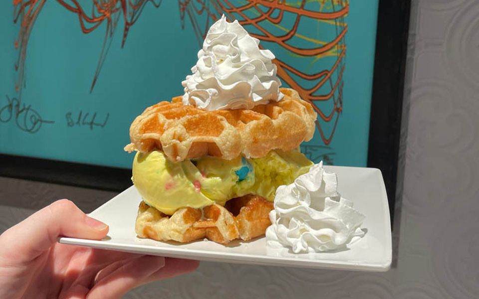 Yummy ice cream and waffle treat with whipped cream